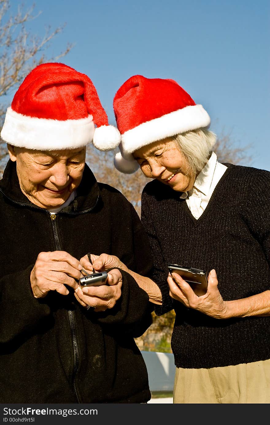 Grandma is showing Grandpa how to enter data into their new handheld computers. Grandma is showing Grandpa how to enter data into their new handheld computers.