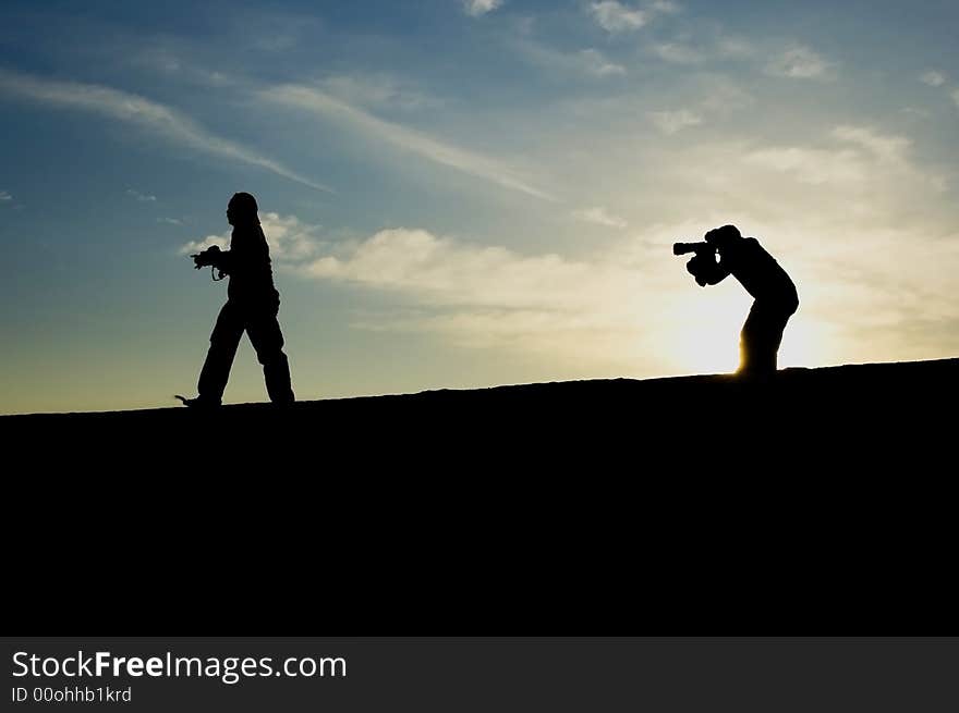 One man walking while the other one was taking a picture. One man walking while the other one was taking a picture.