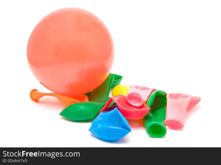 Closeup of a pile of deflated balloons and one inflated