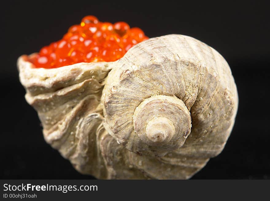 Red caviar on a black background