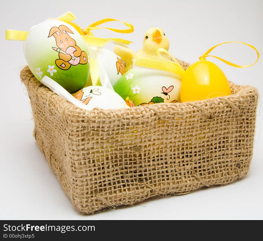 Easter eggs and chick in a cloth basket