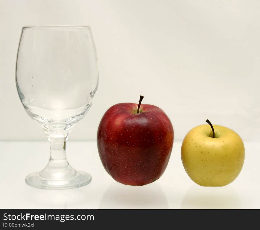 Yellow and red apple and glass. Yellow and red apple and glass