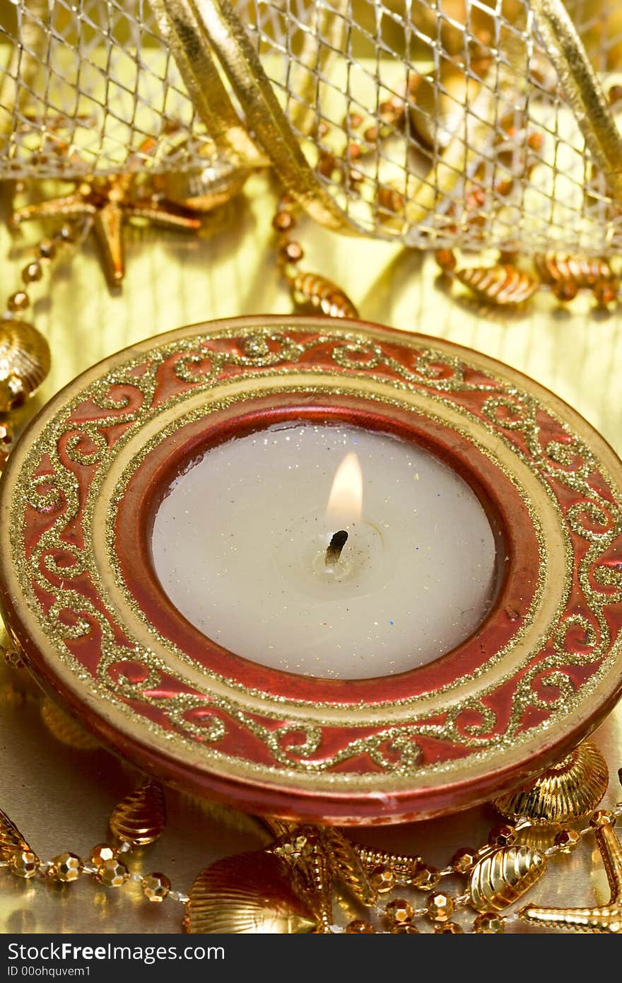 Red candle on golden background