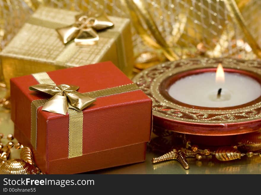 Gift boxes and burning candle