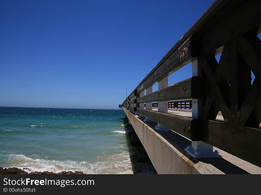 A pier at the beach on a hot day. A pier at the beach on a hot day