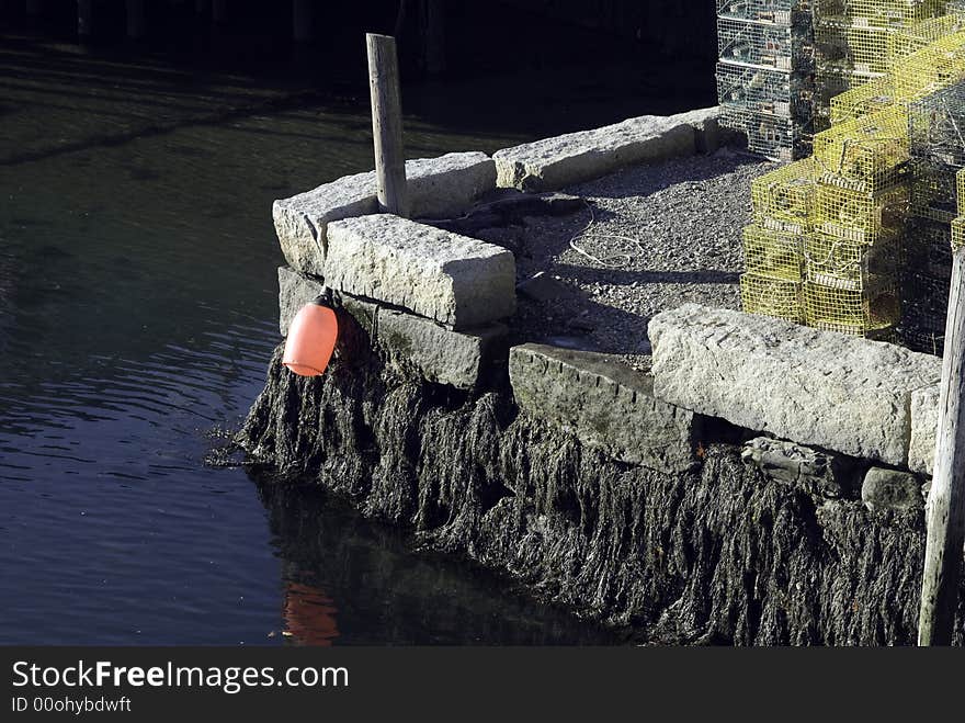 Lobster pots sit on a stone pier in Portsmouth, NH, USA