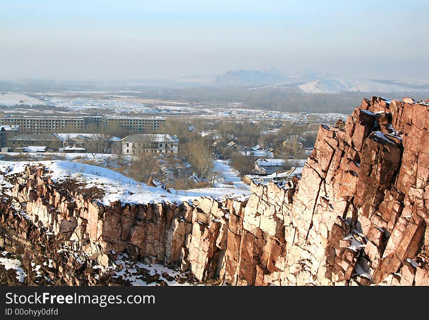 Steep rock in the winter. Village