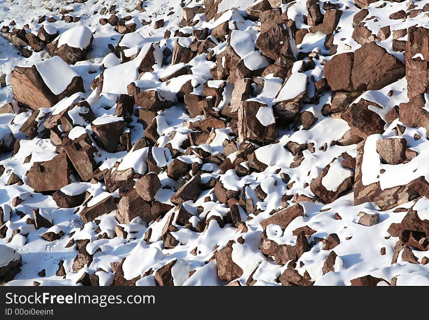 Stones covered snow