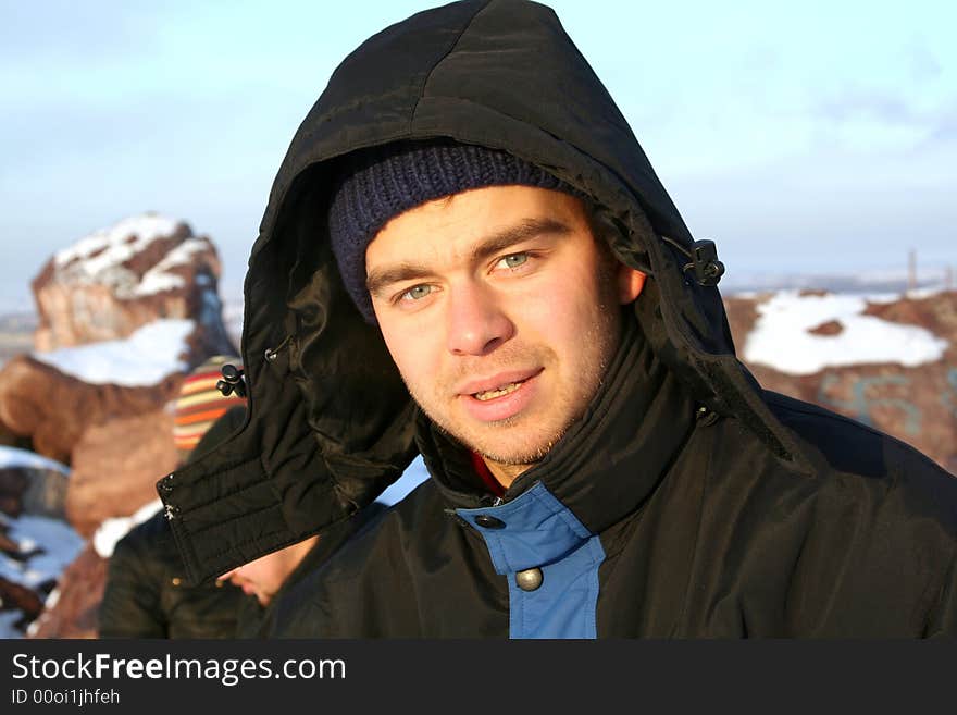 Outdoor portrait of attractive guy in hood. Outdoor portrait of attractive guy in hood