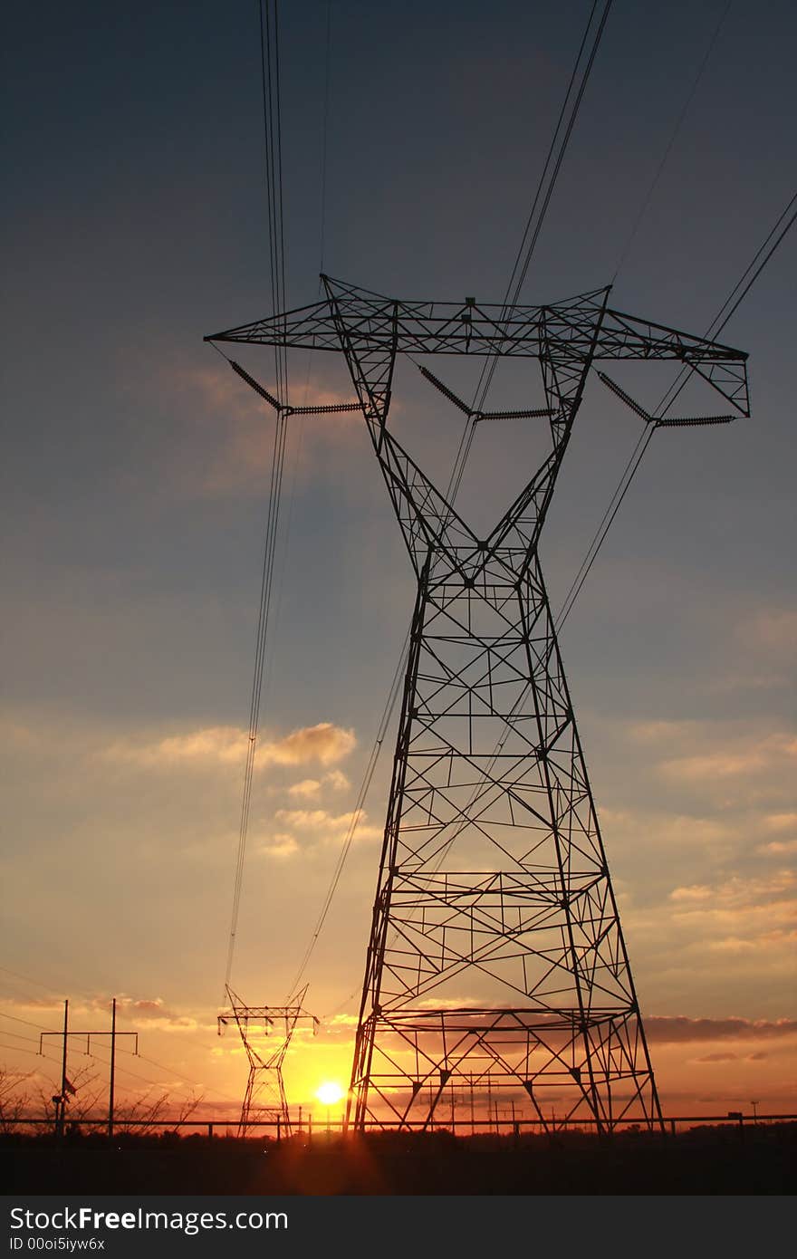 Electric power transmission towers at sunset. Electric power transmission towers at sunset