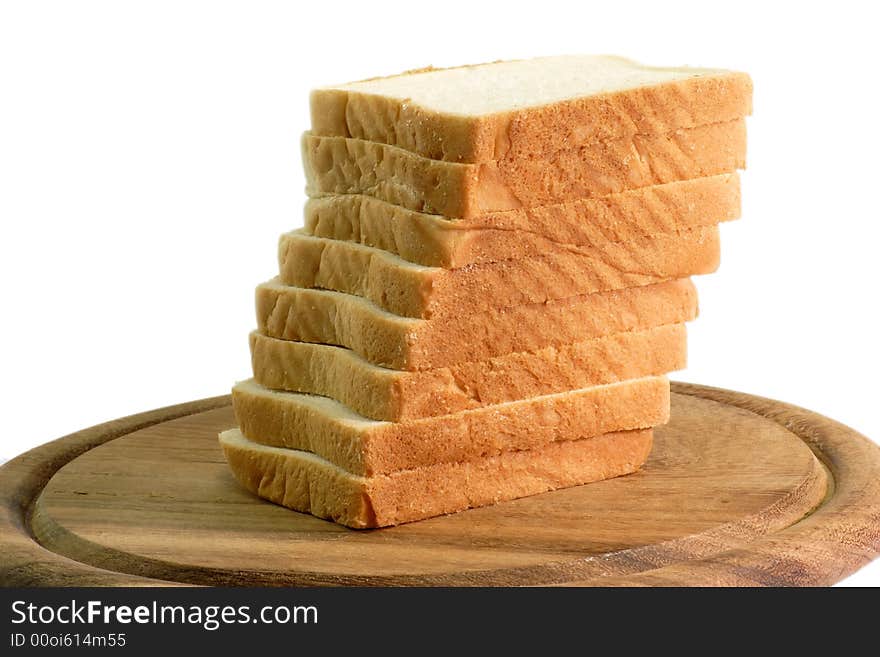 Pile of toast on a wooden kitchen board in white background