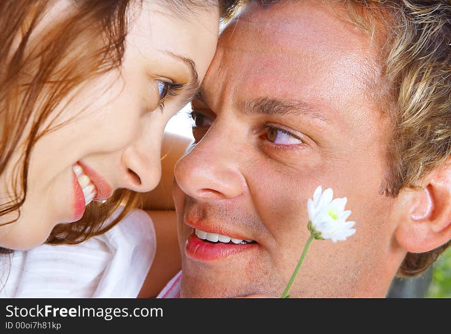 A portrait of attractive couple in summer environment. A portrait of attractive couple in summer environment