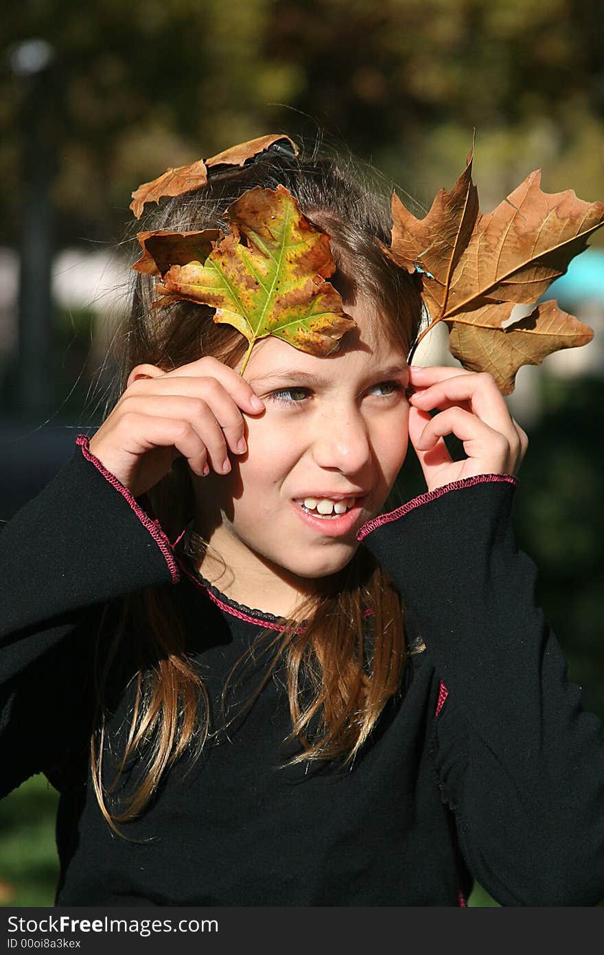 Little girl, well doing something with the leaves of Fall. Little girl, well doing something with the leaves of Fall.