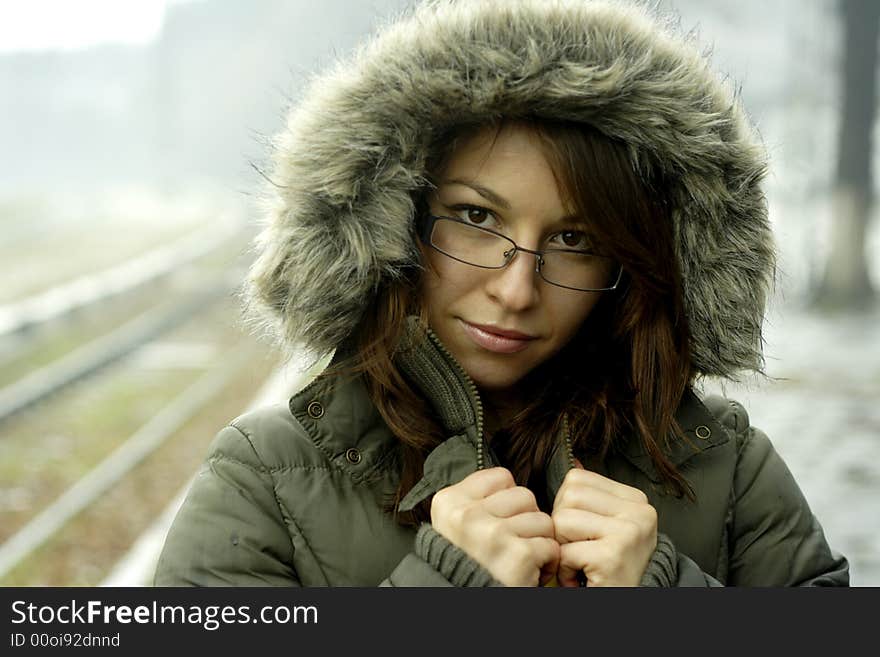 The girl with jacket stands under rain. The girl with jacket stands under rain