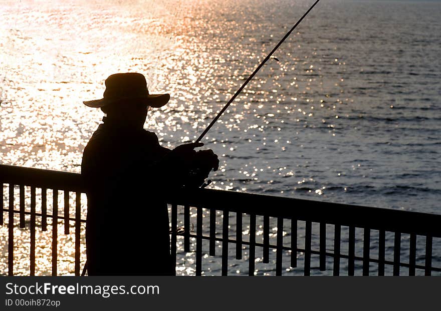 Silhouette image of a fisherman in early morning