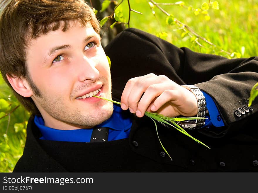 Young strongly dressed businessman with green straw. Young strongly dressed businessman with green straw