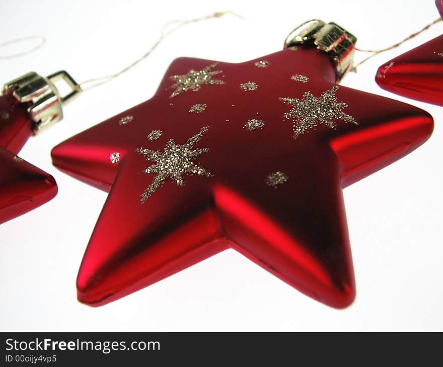 A red Christmas Star sparkling on a white background. A red Christmas Star sparkling on a white background