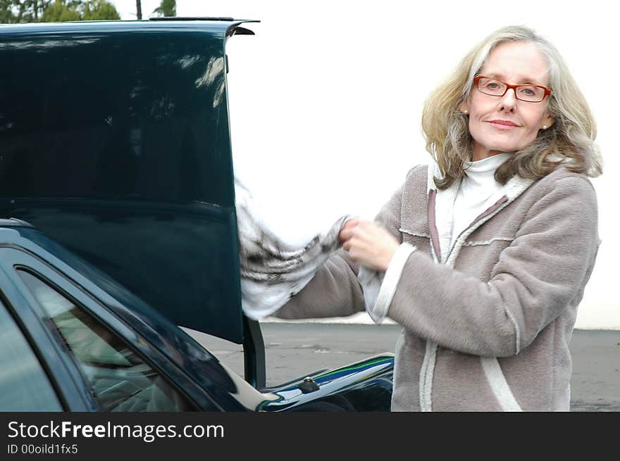 Woman cleaning her car at a carwash.