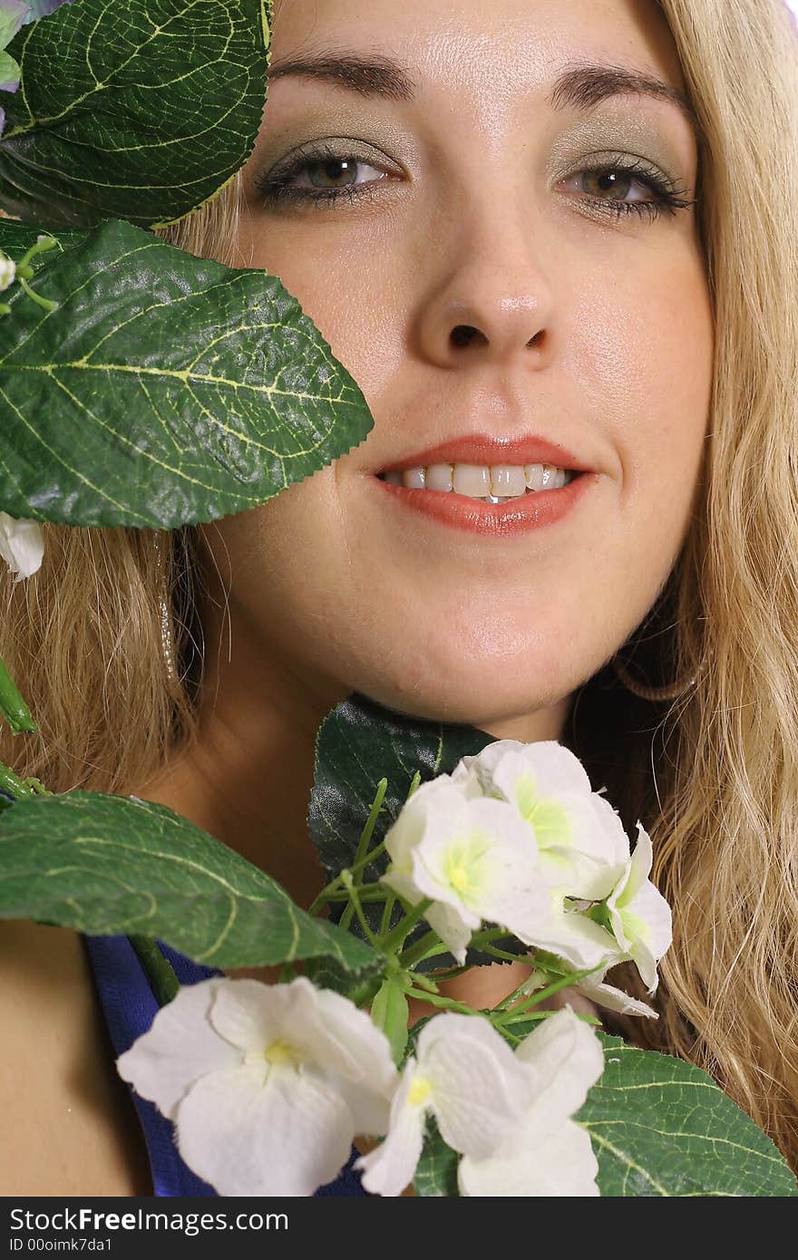 Image of a womans face in a flower headshot