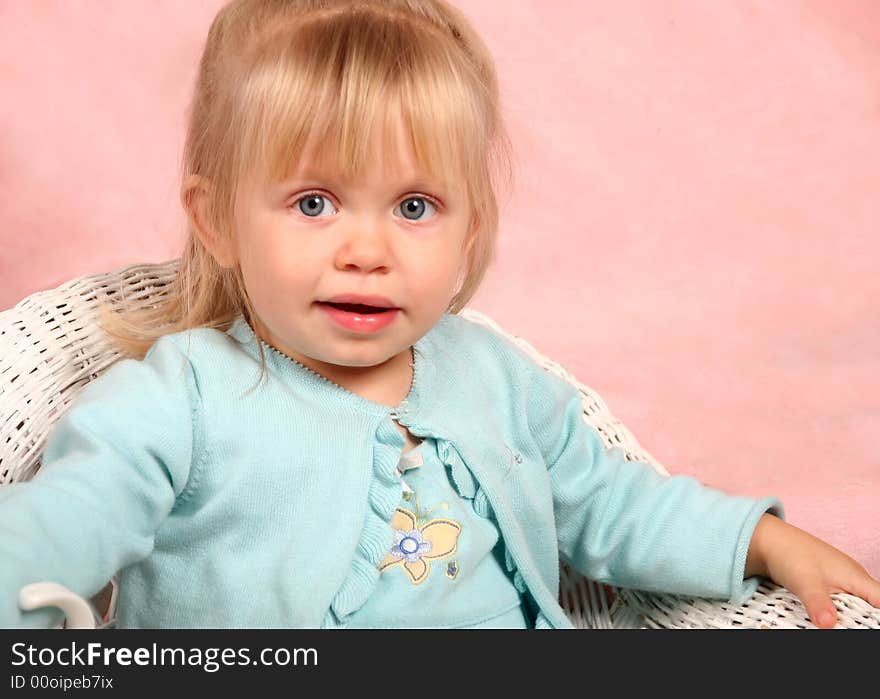 Adorable little blond girl in chair. Adorable little blond girl in chair