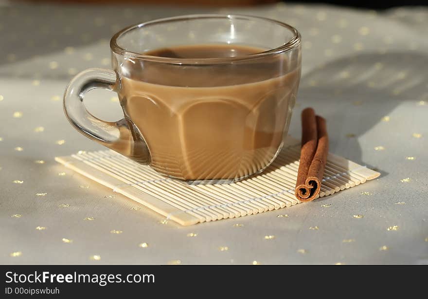 A cup of coffee with a cinnamon stick