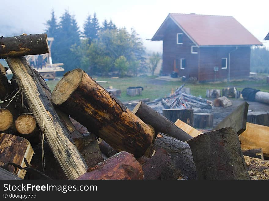 A closeup of fire logs outside cabin in the countryside.