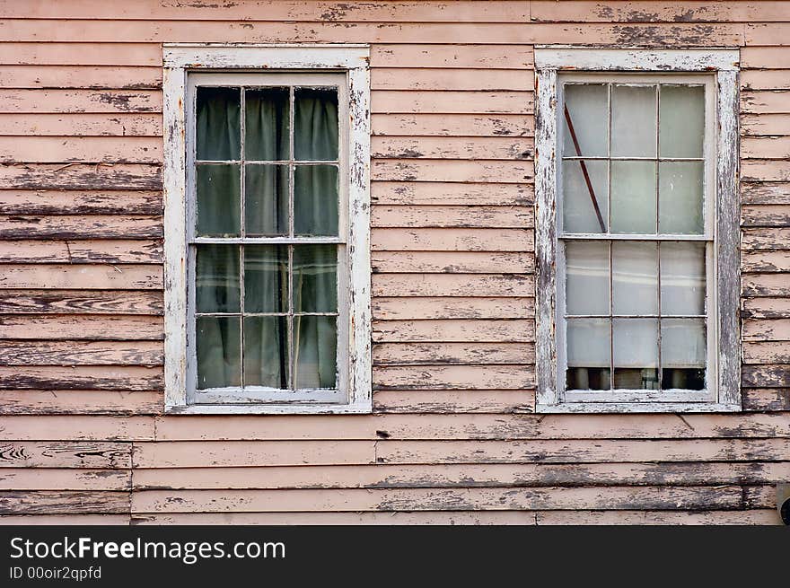 Image of weathered southern home with two windows