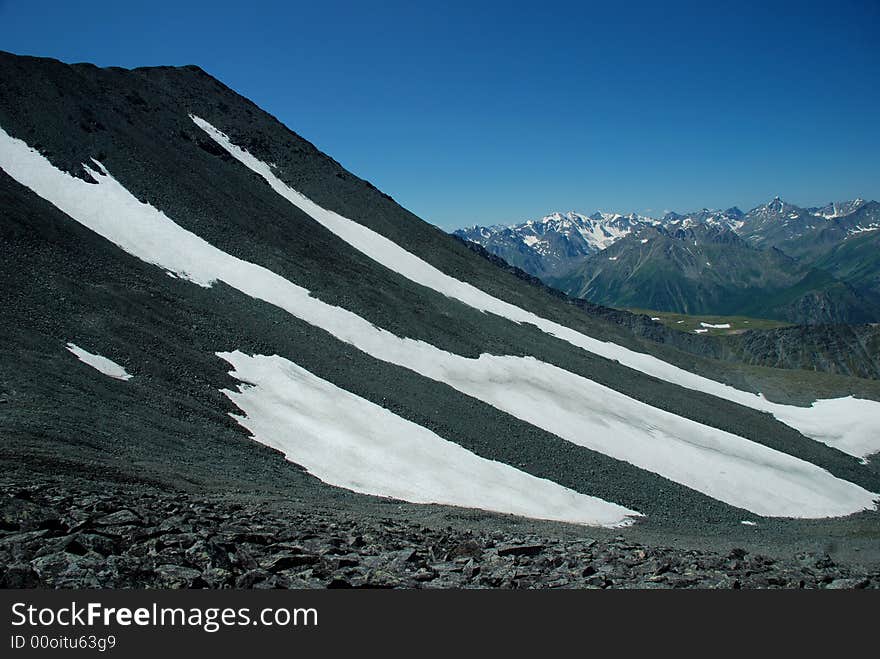 Mountain passage, landscape, snow and stones, panoramic view, Altai, Russia