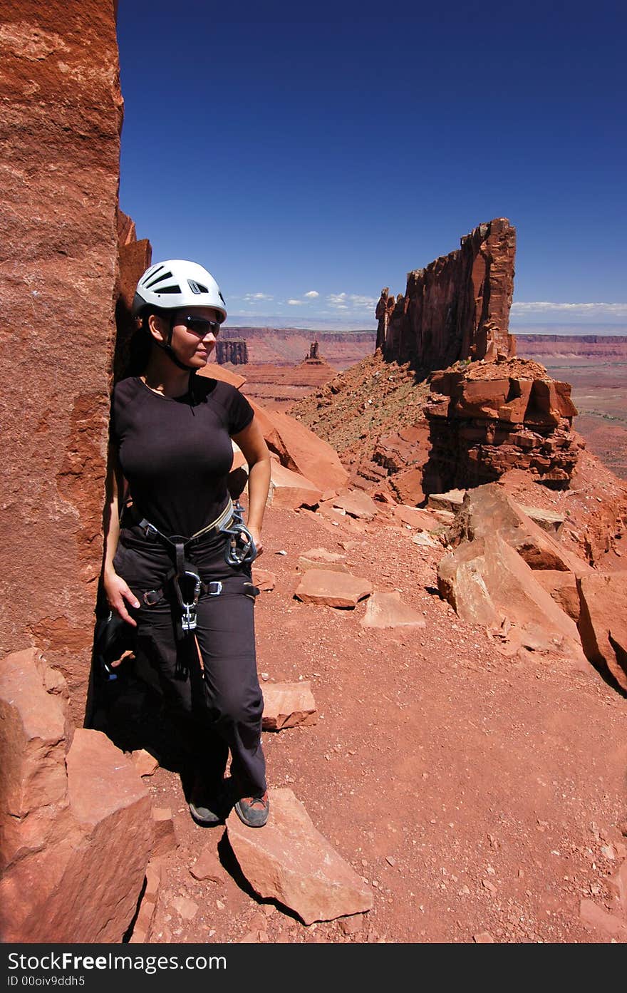 Female climber at the base of Castleton Tower Near Moab Utah. Female climber at the base of Castleton Tower Near Moab Utah