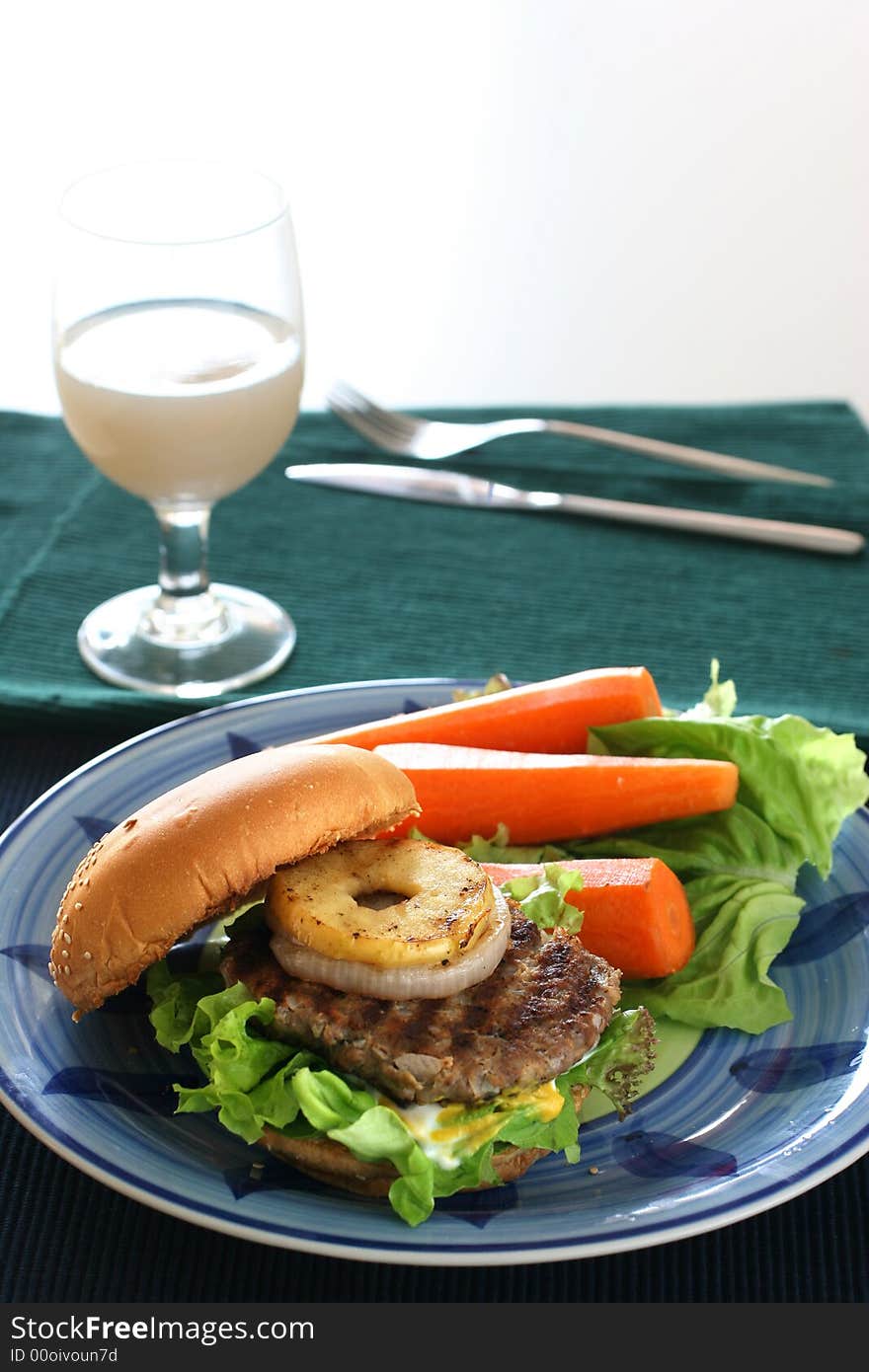 Healthier homemade grilled burger with carrots and plenty vegetables