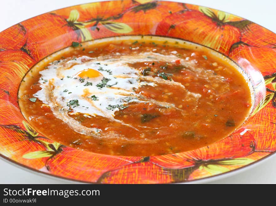 Homemade chunky tomato soup with chopped basil and garlic and a dash of olive oil