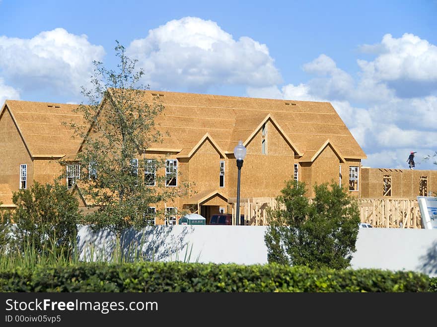 Two story frame condos under construction showing green wood on first floor and construction slab. Two story frame condos under construction showing green wood on first floor and construction slab