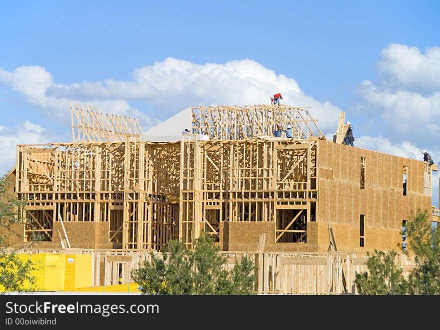 Two story frame condos under construction showing green wood on first floor and construction slab. Two story frame condos under construction showing green wood on first floor and construction slab