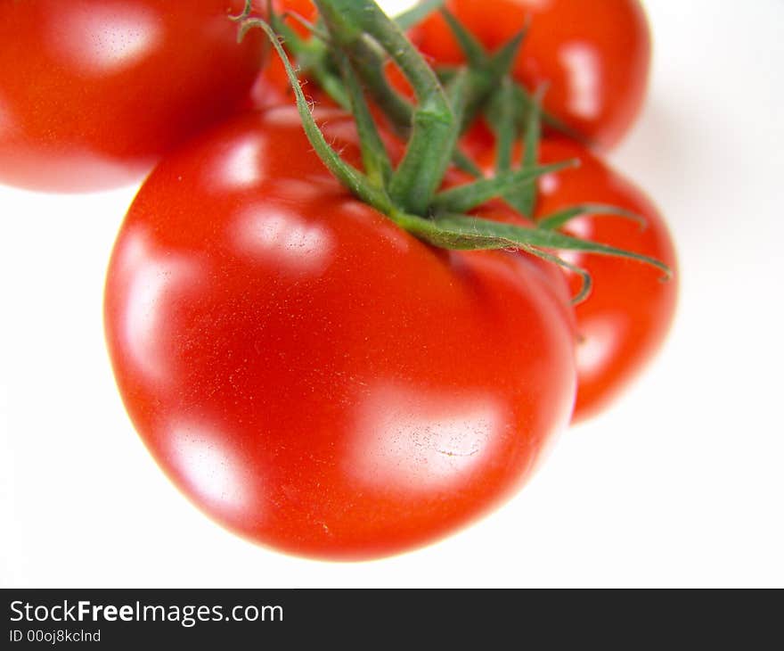 Isolated fresh tomatoes with stems closeup (vivid colors)