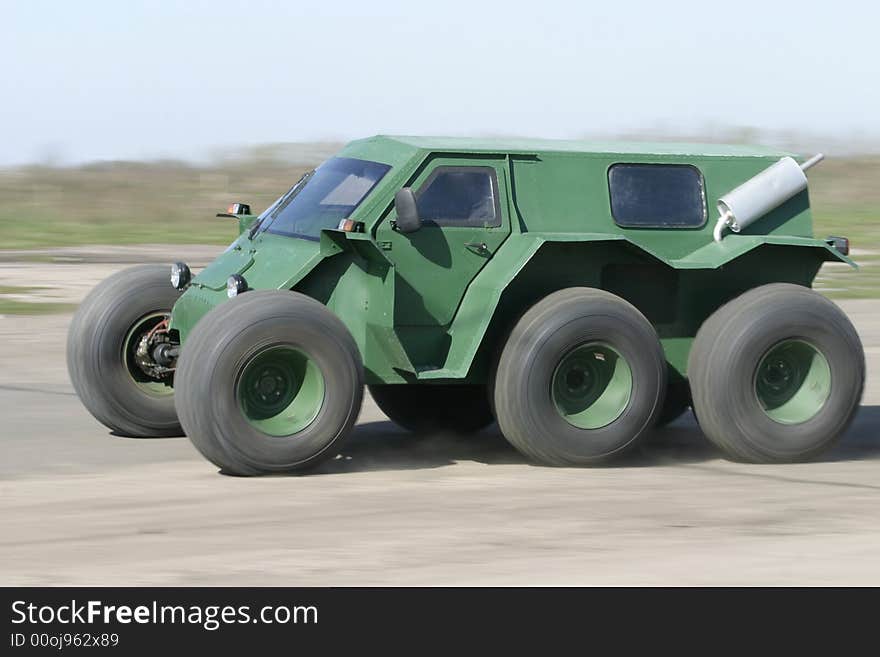 The self-made cross-country vehicle rushes on highway. The self-made cross-country vehicle rushes on highway