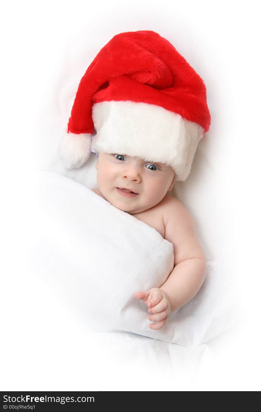 The Child in red hat of Santa on white background. The Child in red hat of Santa on white background.