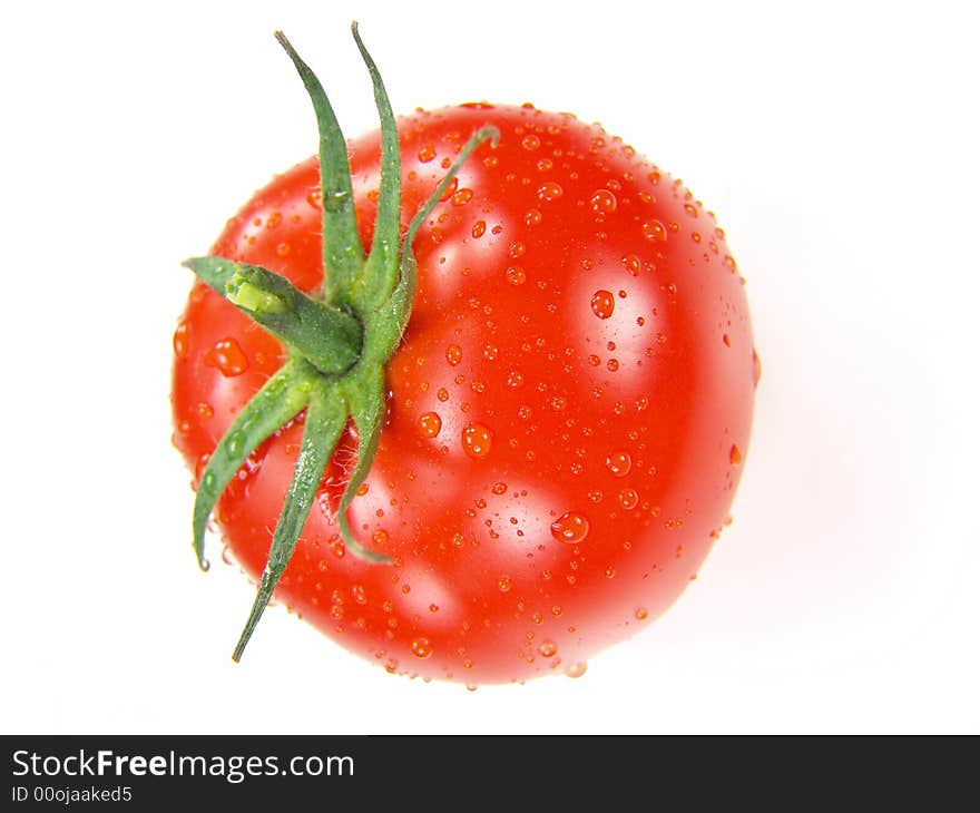 Isolated fresh tomato with stem and water drops close-up (vivid colors)