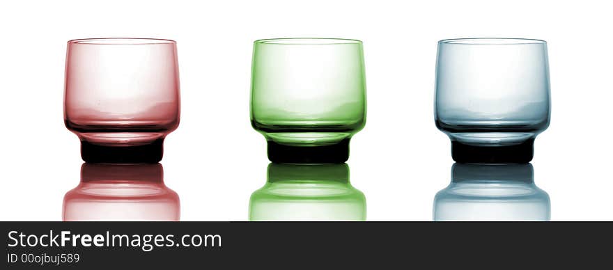 Red, green and blue glass isolated over white background, with reflection. Red, green and blue glass isolated over white background, with reflection