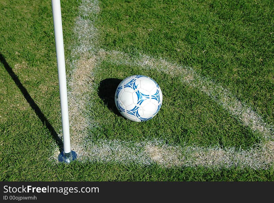 Soccer ball in the corner on a sunny day