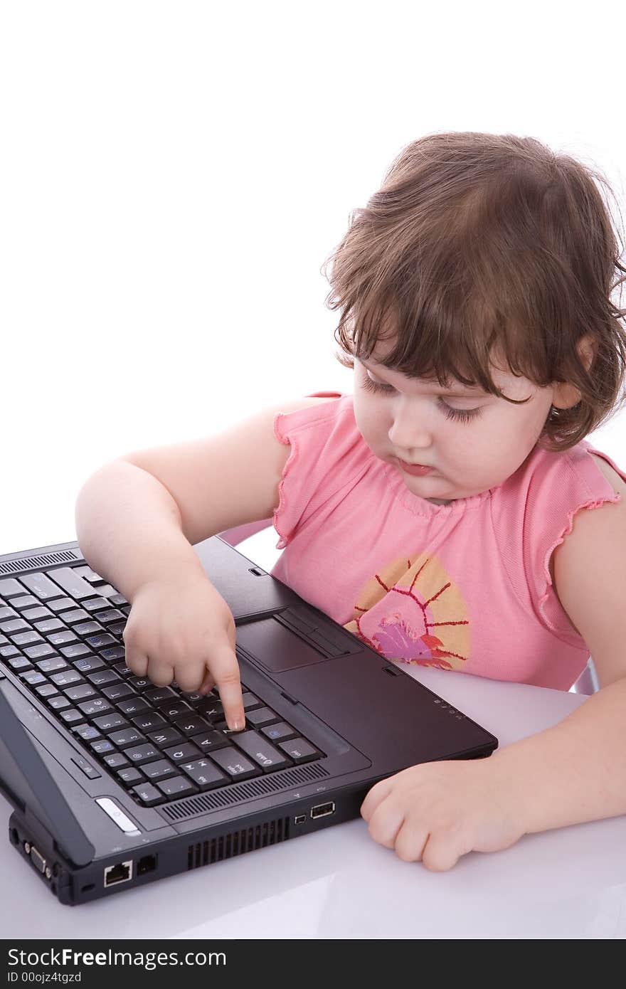 Small child looks at laptop