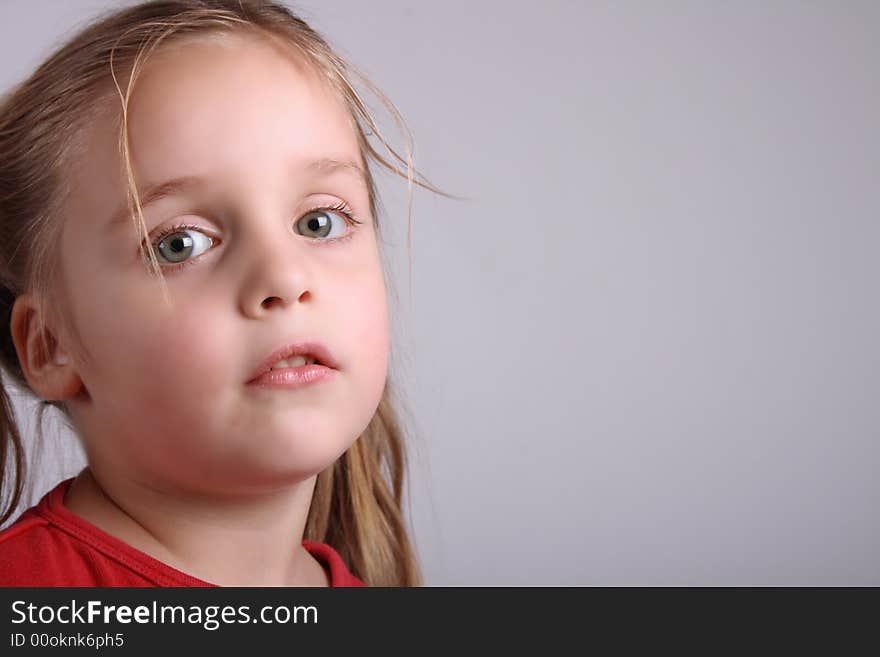 Face of young girl  on the gray background