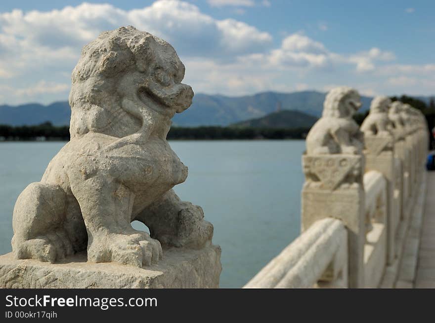 In the Summer Palace, these 544 carved white marble lions, in distinctive postures, sit at the column of the parapets on the 17-arch Bridge, which looks like a rainbow arching over the lake water. 
Beijing, China