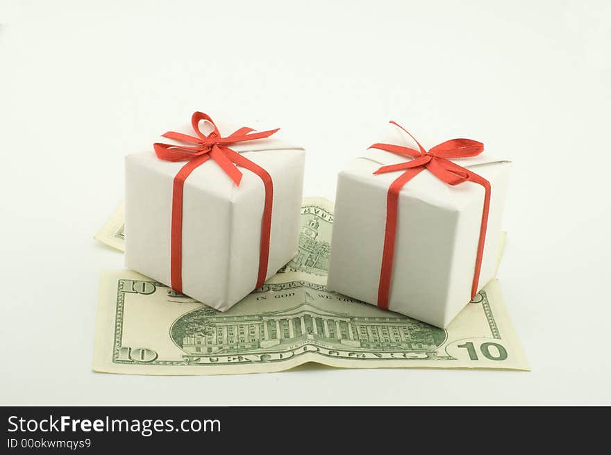 Small white boxes with gifts on dollar denominations. Small white boxes with gifts on dollar denominations