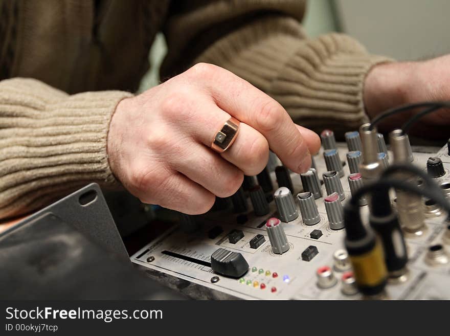 The engineer tuning acoustical frequency of amplifier