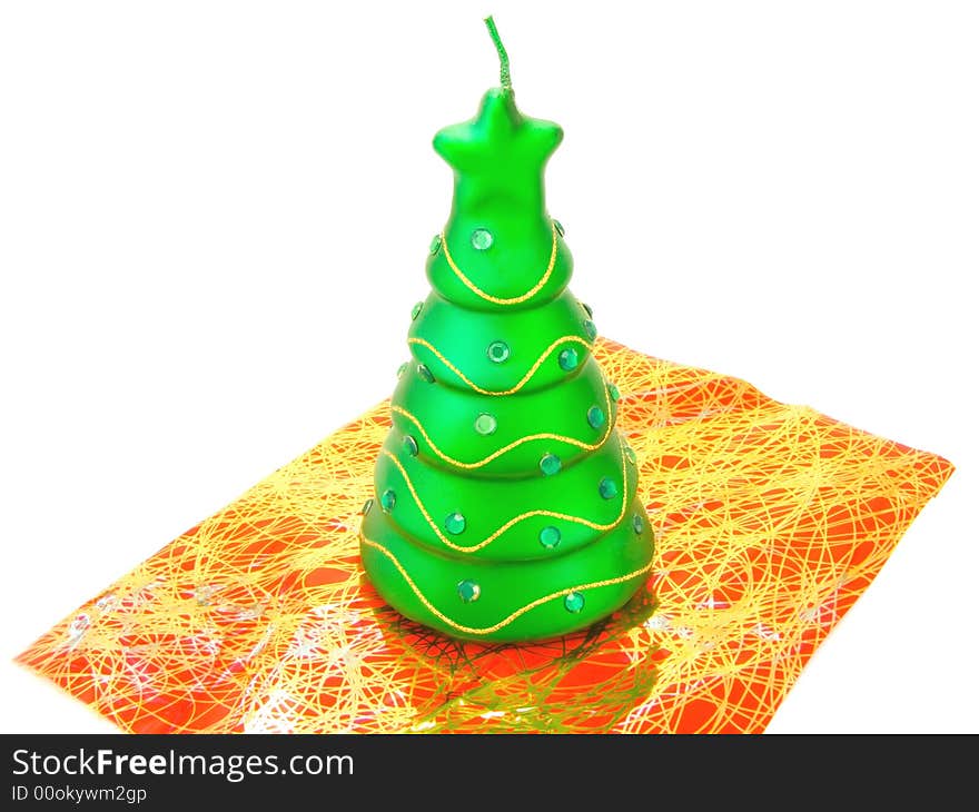 New-year candle in form the decorated fir-tree on a white background. New-year candle in form the decorated fir-tree on a white background