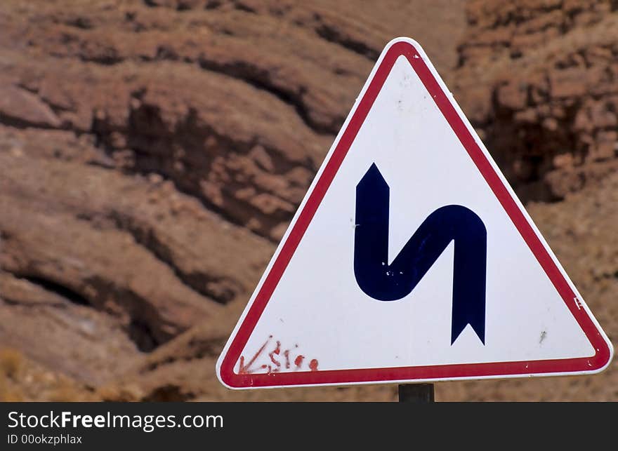 Road sign warning about curves in the Moroccan mountains. Road sign warning about curves in the Moroccan mountains