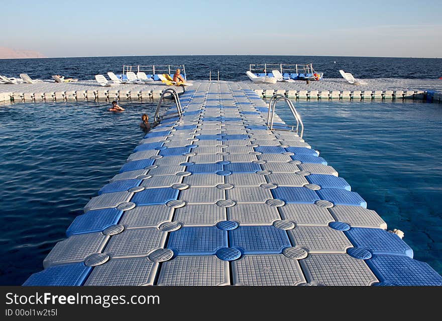 Pontoon bridge with open water swiming pool under coral reef in red sea resort. Pontoon bridge with open water swiming pool under coral reef in red sea resort