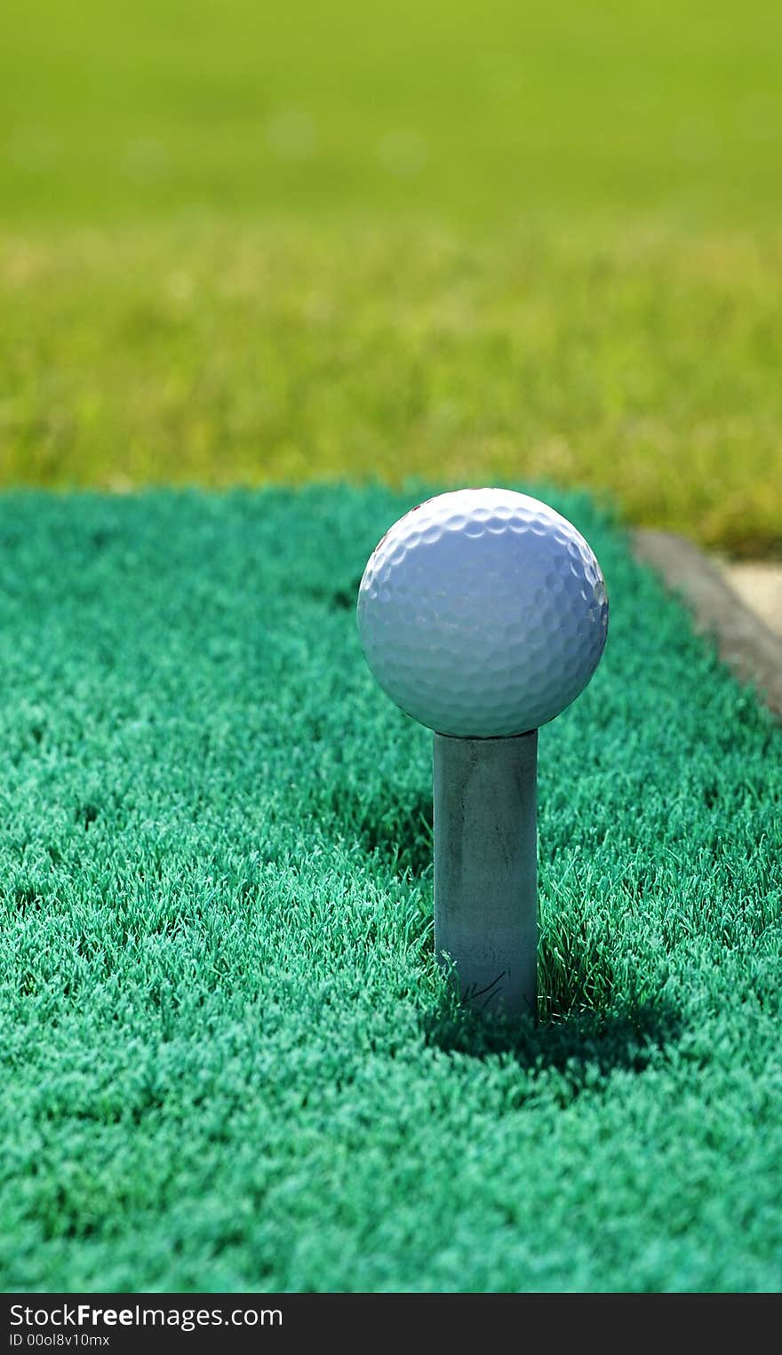 A golf ball on a practice tee