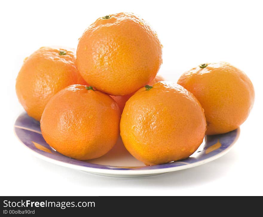 Tangerines on a plate on white background