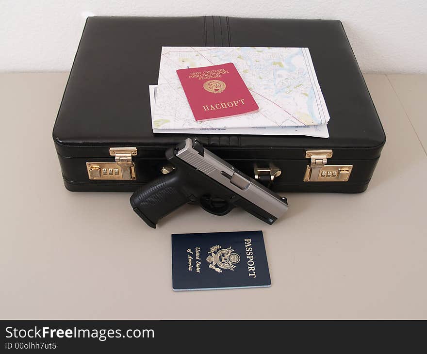 Two passports and suitcase with map and gun for special agent 007